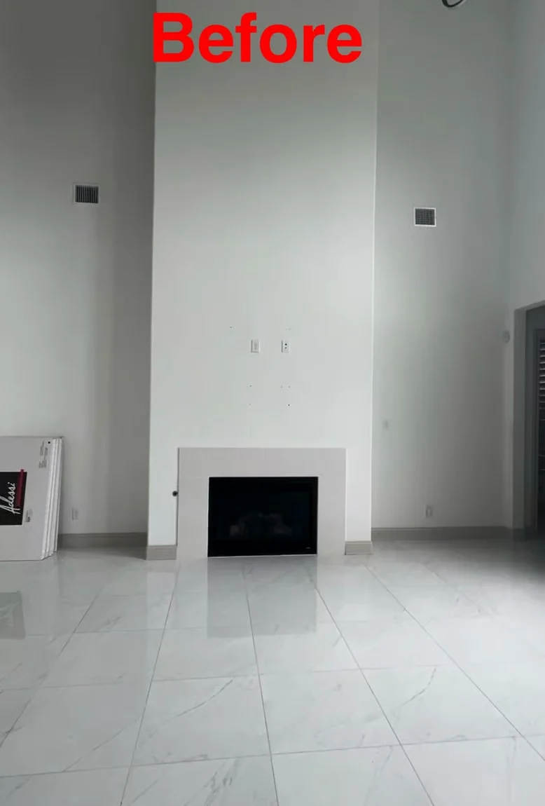 Tall interior wall with a simplified modern fireplace