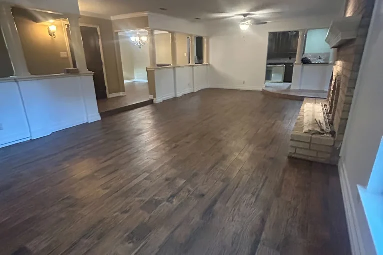 Open great room with newly installed dark wood-look flooring
