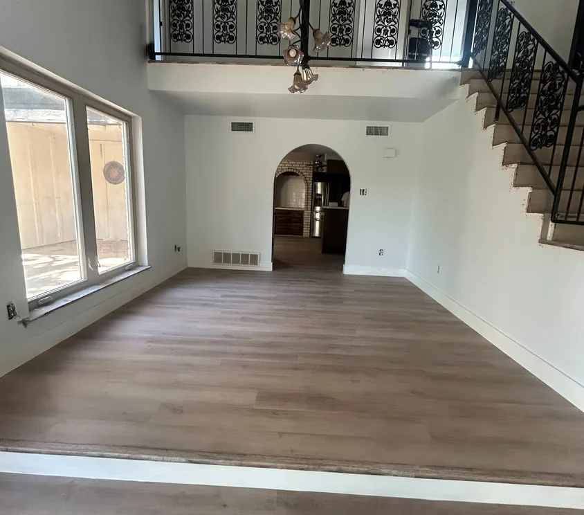 Bright open-plan room with finished wood flooring