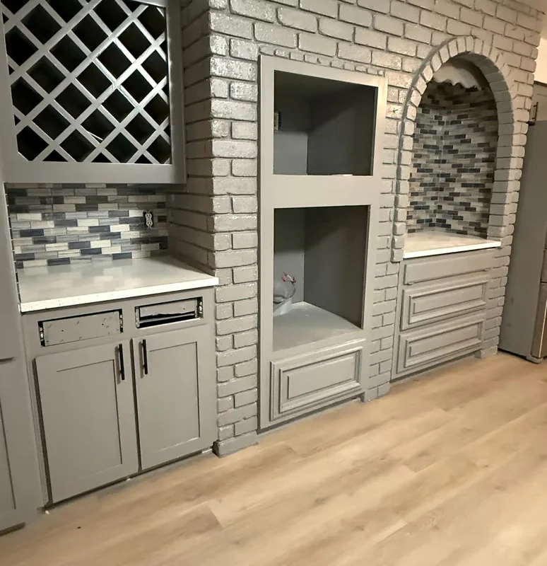 Outdoor kitchen with brick, storage, and patterned tile