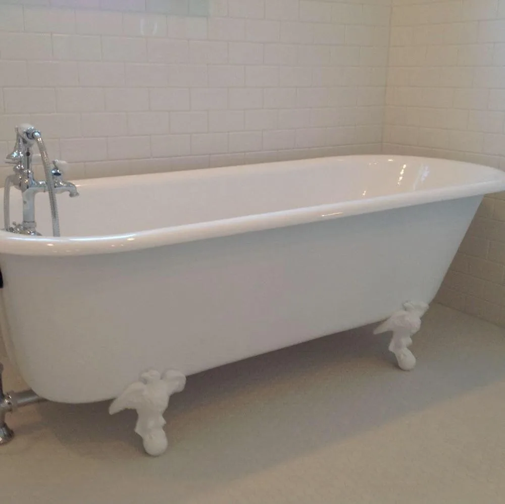 Clawfoot tub in a white subway-tile alcove