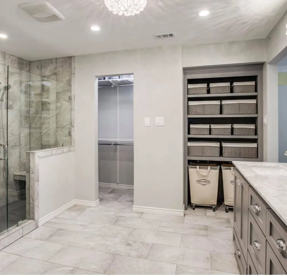 Primary bath and dressing area with glass shower and built-in storage