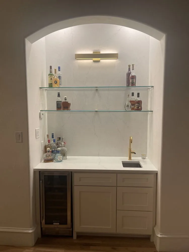 Custom-built wet bar with glass shelving