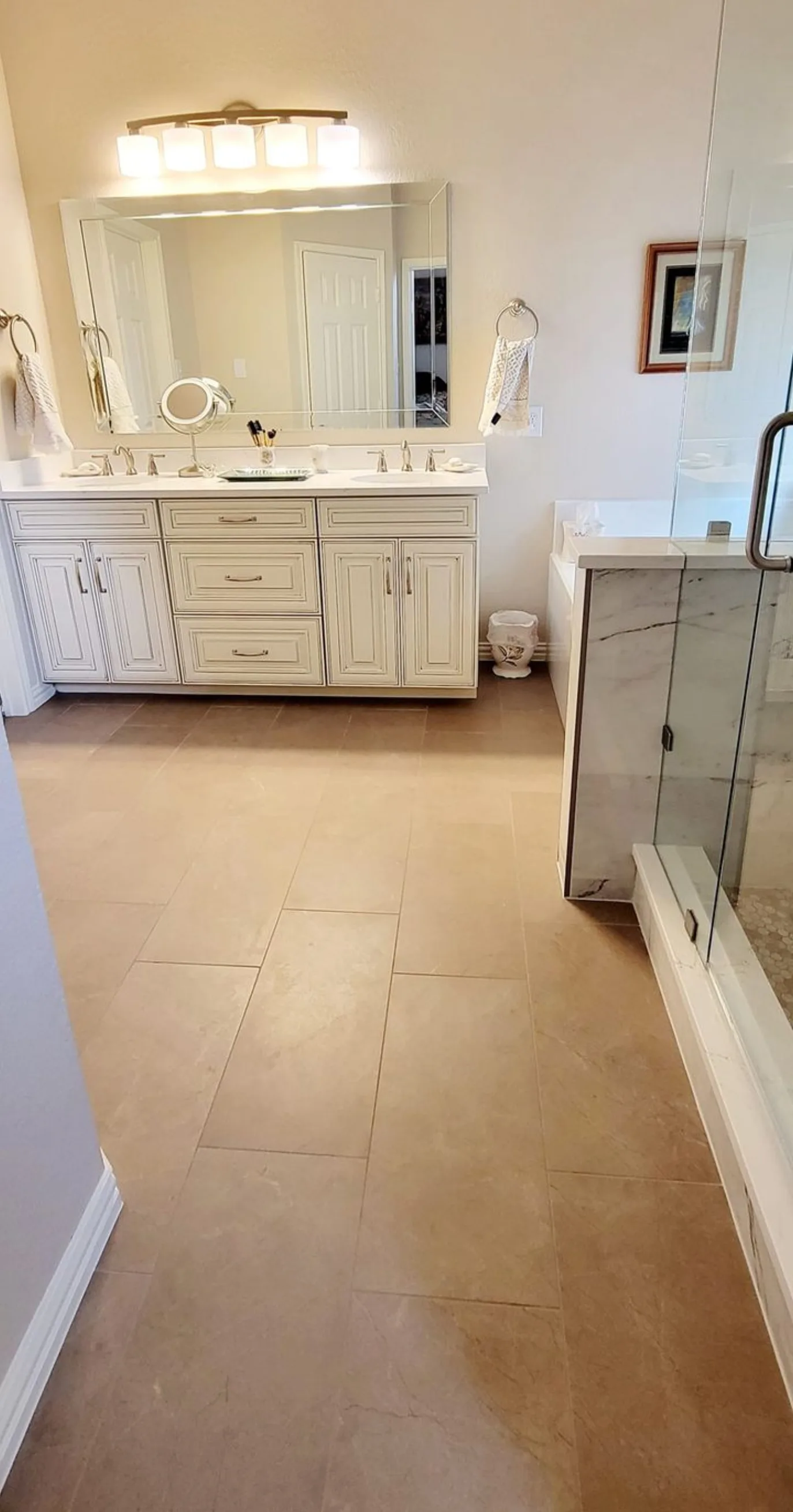 Allen bathroom remodel: cream double vanity with warm-tone tile floor