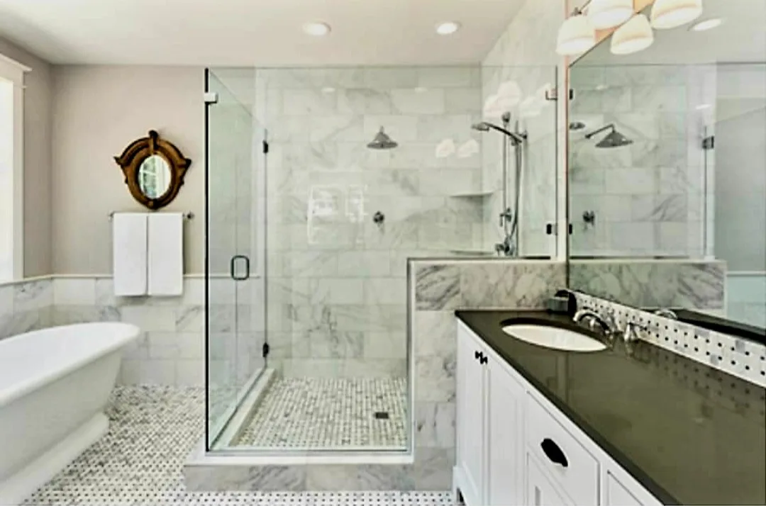 Primary suite with freestanding tub, black granite vanity top, and marble-tiled shower